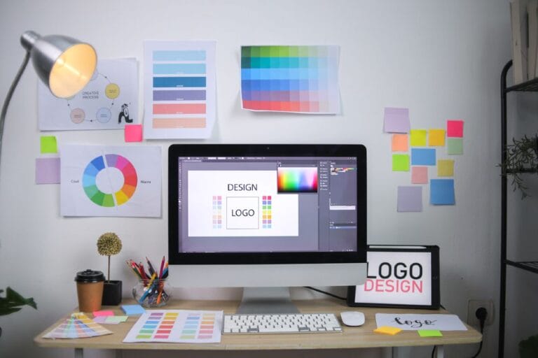Modern Graphic Design Workspace With Computer Showing Logo Conce
